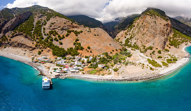 AGIA ROUMELI, CRETE, GREECE - JULY 20 2021: Aerial view of the village of Agia Roumeli at the exit of the Samaria Gorge on the Greek island of Crete.