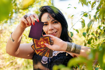 gypsy woman in the outdoors with cards of tarot