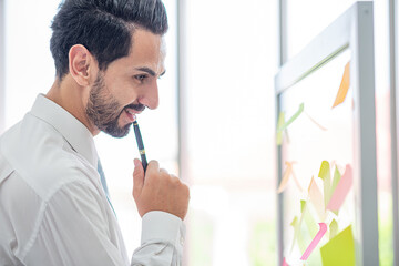 Fototapeta premium business man write pen to post it for idea analysis and planning marketing,goal to success