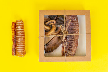 Kit of dried meat treats for training and encouraging dogs. Contents of box are placed next to the...