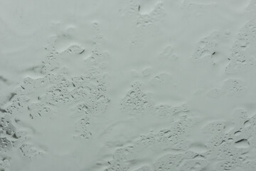 water drops on glass surface, Road view through car window with rain drops, City view through a window with raindrops, rain in the city, Driving in rain, rainy weather.