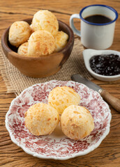 Typical brazilian cheese bun in a basket, coffee and jam