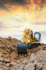Obraz premium Selective focus ,Excavator with Bucket are digging the soil in the construction site on the sunset background
