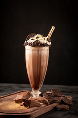 Chocolate milkshake with pieces of chocolate chip cookies.