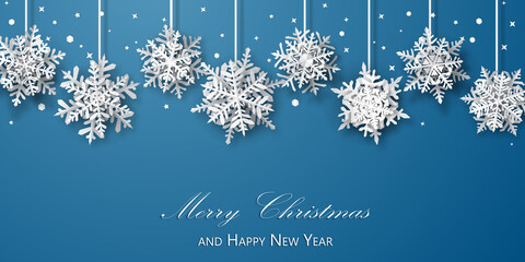 Christmas background of paper snowflakes with soft shadows, white on light blue background