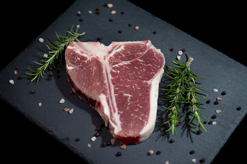 Fresh T-Bone Cut on Dark Granite Counter