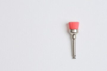 Pink brush for dental resin polishing.
 Brush for dental resin polishing.
Tooth resin polishing concept with space for text.