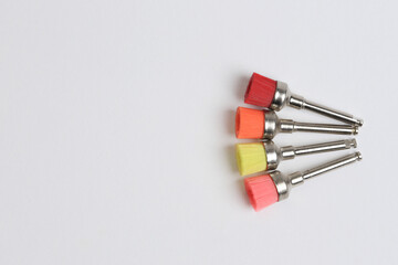 Colored nylon polishing brushes.
Dental supplies for resin polishing.
Dental esthetics concept. - obrazy, fototapety, plakaty