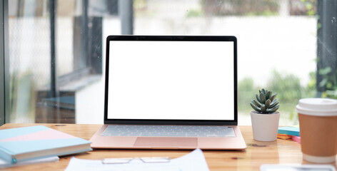 Mockup copy space blank screen laptop and office supplies on white desk.
