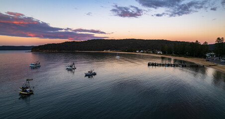 Sunrise panorama over the bay with boats and wharf