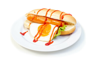Hot Dog (sausage, fried egg and vegetables) with tomato sauce in white plate