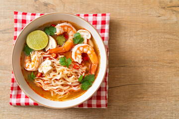 instant noodles ramen in spicy soup with shrimps (Tom Yum Kung)