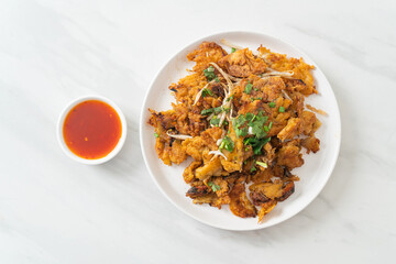 Crispy fried mussel pancake with egg