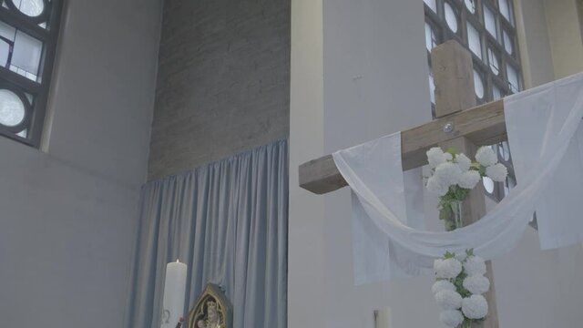 Cross decorated with a white cloth in a church at Easter