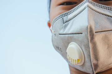 Coronavirus,COVID-19,PM2.5,N95,Portrait Asian children girl wear N95 mask to protect PM 2.5 dust and air pollution.