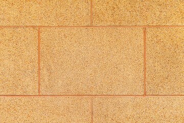 Fototapeta premium Brown granite tiled wall with vintage pattern texture and background seamless