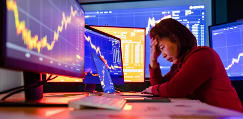 Upset unsuccessful broker trader sit stress depressed at working office desk in trading room hold...