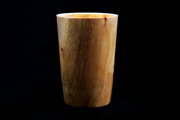 A manufactured wooden glass in black background in HD size