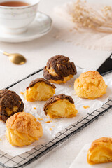 Choux pastry  is a delicate pastry dough used in many pastries. It contains only butter, water, flour, and eggs. Choux pastries are sometimes filled with cream after baking to make cream puffs 