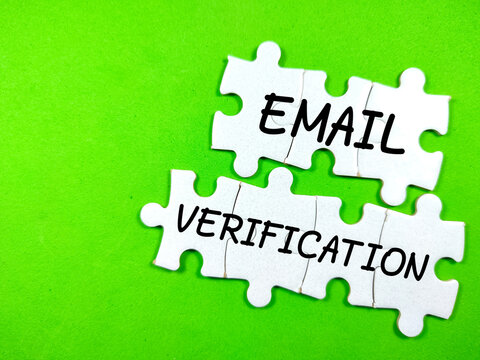 Text EMAIL VERIFICATION on jigsaw puzzle on a green background.