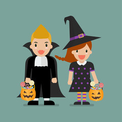 Children with pumpkin basket dressed in Halloween costumes