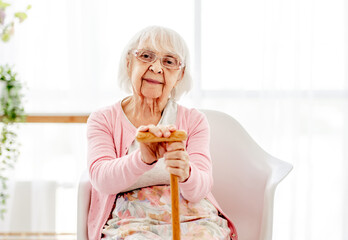 Senior woman with walking stick