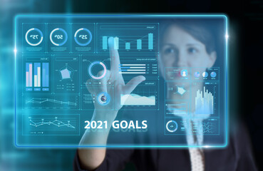 Business, Technology, Internet and network concept. Young businessman working on a virtual screen of the future and sees the inscription: 2021 goals