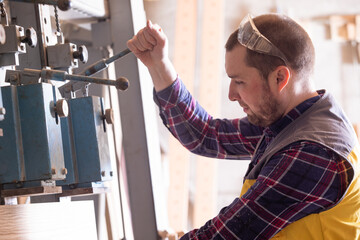 Closeup view man holding hydraulic press lever