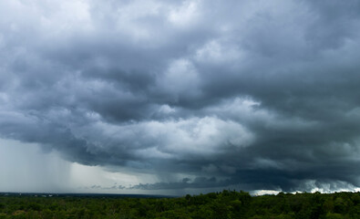 Naklejka na ściany i meble Storm clouds with the rain. Nature Environment Dark huge cloud sky black stormy cloud