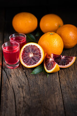 .Sliced Sicilian Blood oranges fruits over old dark wooden background.