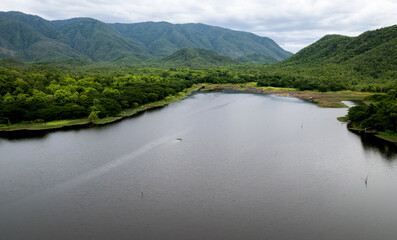 Obraz premium beautiful lake above the dam among blue sky clouds and mountains,lake mountain view