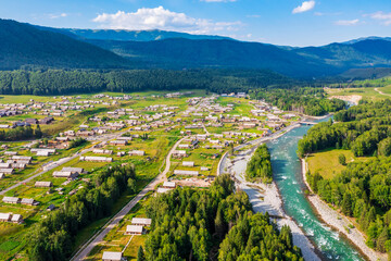 Fototapeta na wymiar Beautiful Hemu Village with natural scenery in Xinjiang,green mountain and forest with rivers.Hemu Village is a famous travel destination in China.Aerial view.