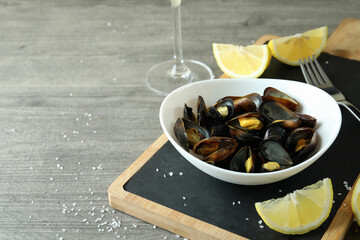 Concept of delicious food with mussels on gray textured table