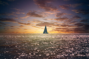 Small sailboat float on Croatia sea at sunset cloudy sky