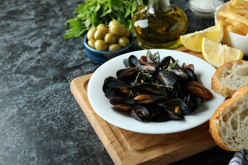Concept of delicious food with mussels on black smokey table