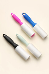 Different lint rollers on color background