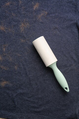 Lint roller on clothes with pet hair, closeup