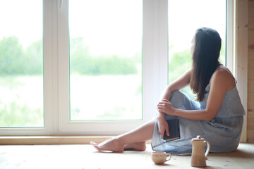 A girl at the window in the house