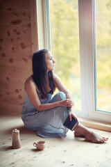 A girl at the window in the house