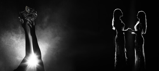 Silhouette abstract of two hands try to reach Diamond Crown as Miss Beauty Queen Pageant Contest as final competition, finale winner moment hold hand together. Backlit smoke copy space © Jade