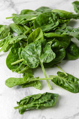 Fresh spinach leaves on light background