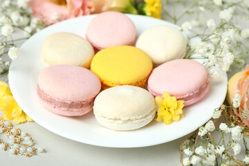 Female accessories and macaroons on light gray background