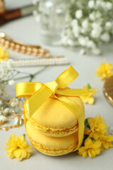 Female accessories and macaroons on light gray background