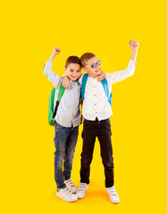 Fototapeta premium Two school friends stand in an embrace and smile