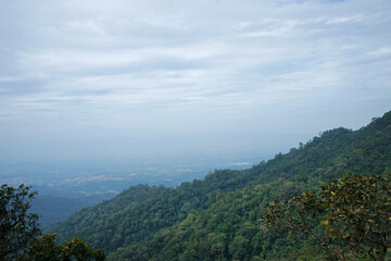 Natural landscape of green mountain range with cloudy blue sky