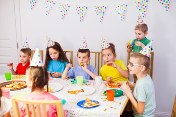 the group of children celebrating a birthday at home