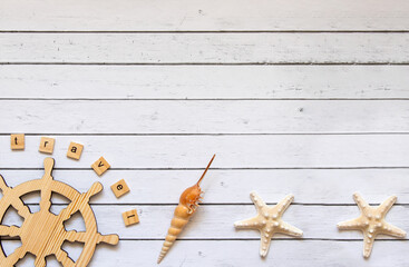Layout for travel: starfish, shells and souvenirs on a light wooden background. A place to copy.