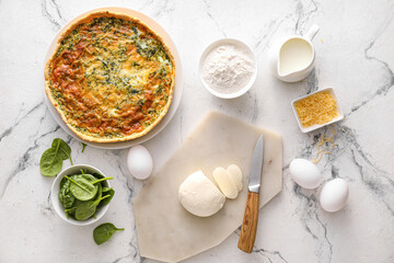 Spinach tart and ingredients on light background