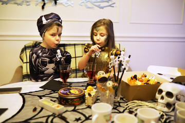 happy family with childrens in costumes and makeup on a celebration of Halloween