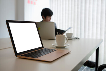 Mock up computer laptop and coffee cup on white office desk.